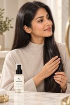 Applying MAISONEVIE daily hair treatment onto dry split ends in front of a mirror to enhance hair manageability and combability.
